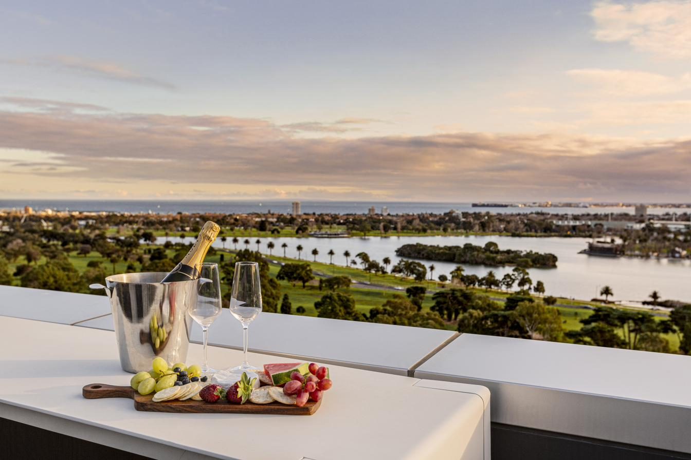 Champagne on balcony at sunset